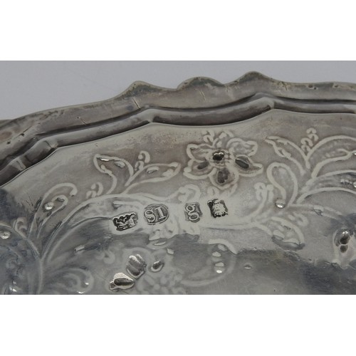 254 - A GEORGE III SILVER SALVER, circular form with scroll edge, with blossoming stems chased decoration ... 