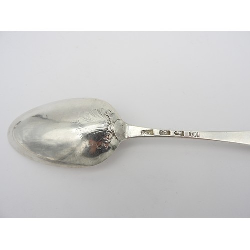 264 - A SET OF FOUR GEORGE III SILVER TABLE SPOONS, scroll back bowls with inscription and insignias to re... 