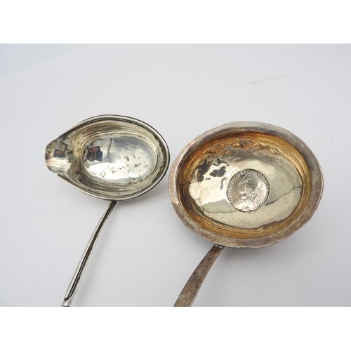 231 - TWO GEORGE III SILVER TODDY LADLES, both with twist handles, one inset with a George II silver shill... 