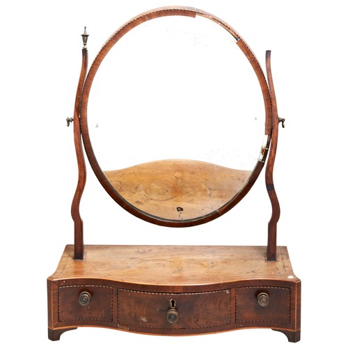 92 - A GEORGE III MAHOGANY SERPENTINE TOILET MIRROR, CIRCA 1800, the oval adjustable mirror with chevron ... 