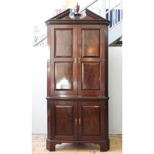 44 - AN IMPRESSIVE GEORGE III MAHOGANY FREE STANDING CORNER CABINET, the broken arch pediment centred by ... 