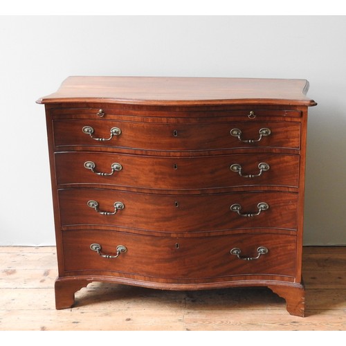 43 - A GEORGE III BACHELOR'S MAHOGANY CHEST OF DRAWERS, CIRCA 1820, elegant serpentine form, the shaped t... 