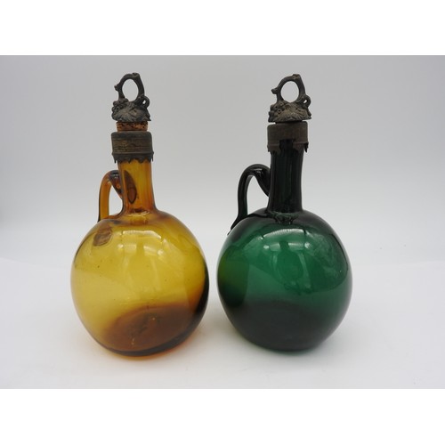 119 - TWO EARLY VICTORIAN FLAGON DECANTERS, CIRCA 1840, hand blown in Bristol Green and amber glass, both ... 