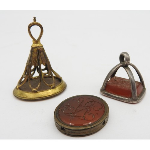 361 - THREE 19TH CENTURY INTAGLIO FOBS, all with incised Carnleian panels, the largest a gilt brass fob wi... 