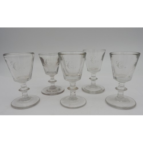 117 - FIVE LATE GEORGE III GIN OR DRAM GLASSES, CIRCA 1820, the tapered heavy baluster bowls engraved with... 