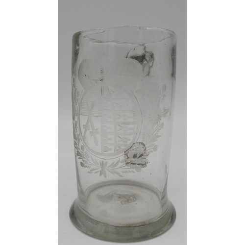 118 - A GEORGE III GLASS TANKARD, CIRCA 1820, with etched heraldic crest cartouche flanked by foliate bord... 