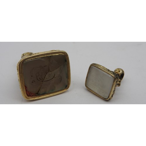 360 - TWO GOLD AND WHITE AGATE INTAGLIO FOBS, CIRCA 1830, the gold fob featuring a central pineapple decor... 