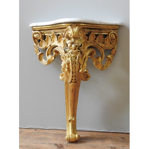 32 - A LATE 19TH CENTURY FRENCH GILT WOOD CONSOLE TABLE, in the Rococo style, ornate carved scroll foliat... 