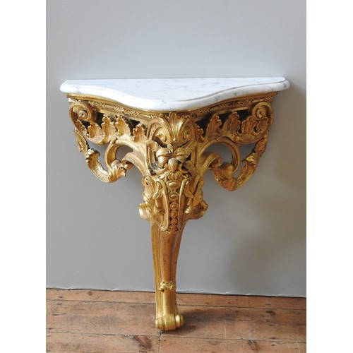 32 - A LATE 19TH CENTURY FRENCH GILT WOOD CONSOLE TABLE, in the Rococo style, ornate carved scroll foliat... 