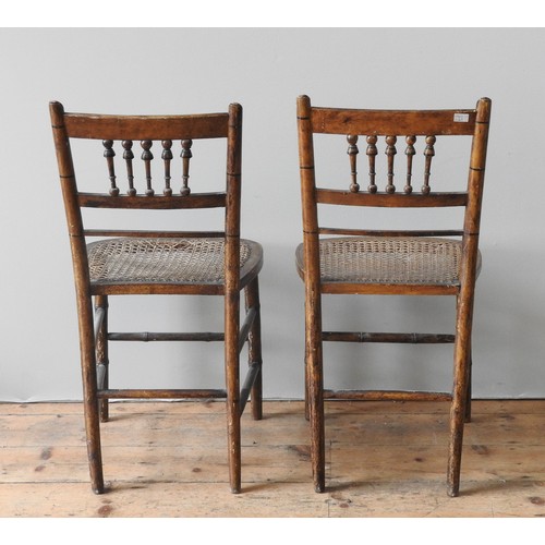 26 - A PAIR OF REGENCY FAUX BAMBOO CHAIRS, CIRCA 1820, floral painted top rail over knopped baluster spin... 