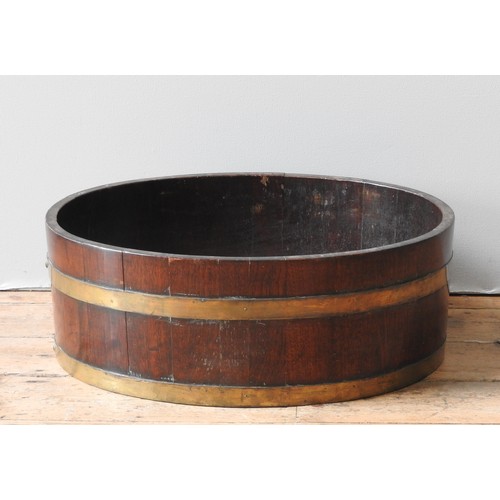 22 - A GEORGE IV MAHOGANY COOPERED WINE COOLER, CIRCA 1835, brass banded oval form23 x 52 x 65 cm