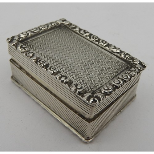 239 - A VINTAGE SILVER ROUGE BOX, rectangular form, engine turned with a chased floral border, the hinged ... 