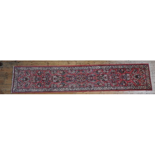 72 - A HAND KNOTTED PERSIAN HALL RUNNER, 20TH CENTURY, decorated with floral sprays within a floral patte... 