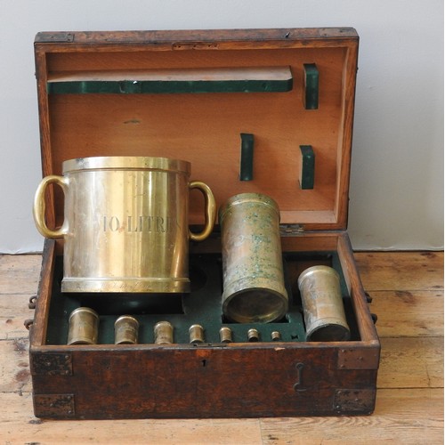 102 - A LATE 19TH CENTURY SET OF CASED COPPER ALLOY CYLINDRICAL MEASURES BY W & J AVERY LTD, missing a... 