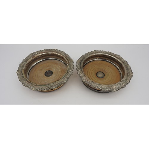 230 - A PAIR OF SILVER PLATED WINE COASTERS, LATE 19TH CENTURY, circular form with ornate scrolling gadroo... 