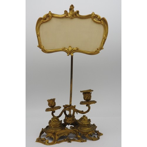 411 - AN UNUSUAL FRENCH GILT METAL ROCOCO INK STAND, EARLY 19TH CENTURY, adjustable cartouche shaped scree... 