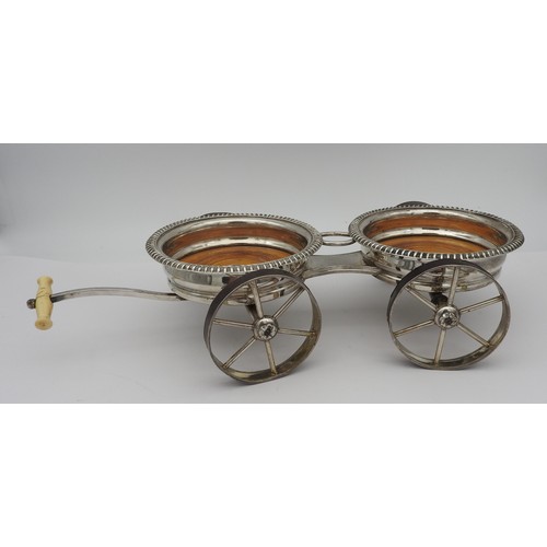 234 - A 19TH CENTURY SHEFFIELD PLATE TWIN COASTER CARRIAGE, the two gadrooned edge coasters with spoked wh... 