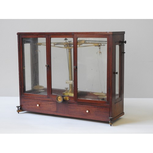 103 - A SET OF 19TH CENTURY LABORATORY SCALES, in a glass panelled mahogany case with two glazed doors abo... 