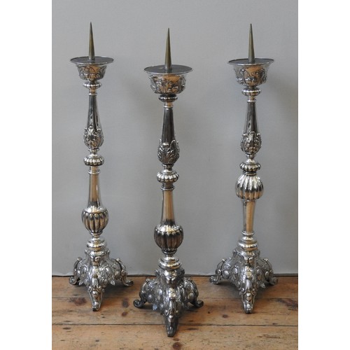 80 - A GROUP OF THREE SILVER PLATED ALTAR CANDLE STANDS, 19TH CENTURY, knopped fluted baluster columns ra... 