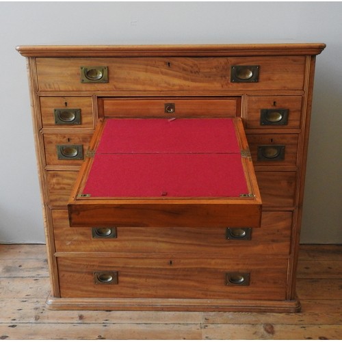 16 - A LATE 19TH CENTURY CAMPHORWOOD CAMPAIGN CHEST, the upper central drawer opening to reveal a fold ou... 