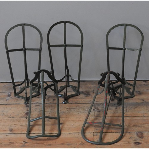 101 - A GROUP OF FIVE CAST-IRON TACK ROOM SADDLE RACKS, 19TH CENTURY, painted green29 x 49 cm and similar... 