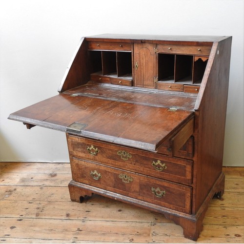 47 - A MID 18TH CENTURY WALNUT BUREAU,  the crossbanded fall front enclosing  a compartmented interior wi... 