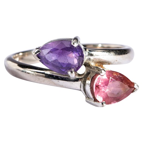 261 - AN AMETHYST AND PINK TOURMALINE RINGthe pear-cut stones, each three claw set, in cross over formatio... 