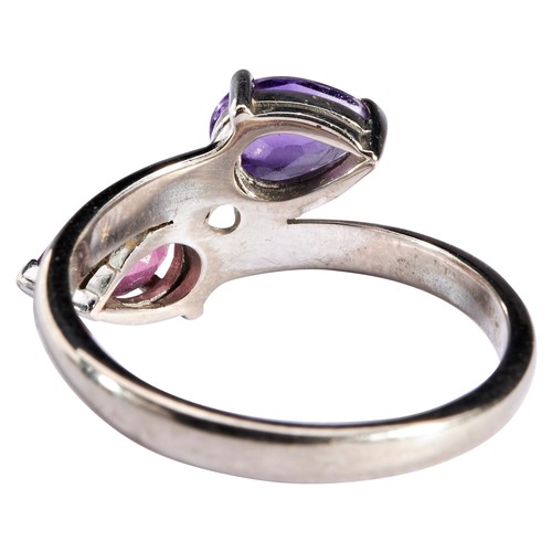 261 - AN AMETHYST AND PINK TOURMALINE RINGthe pear-cut stones, each three claw set, in cross over formatio... 