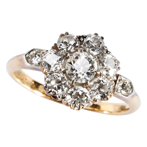 304 - AN EDWARDIAN DIAMOND CLUSTER RINGcomposed as a flower cluster of eight old- cut diamonds, between di... 