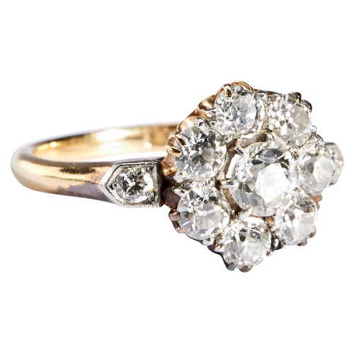 304 - AN EDWARDIAN DIAMOND CLUSTER RINGcomposed as a flower cluster of eight old- cut diamonds, between di... 