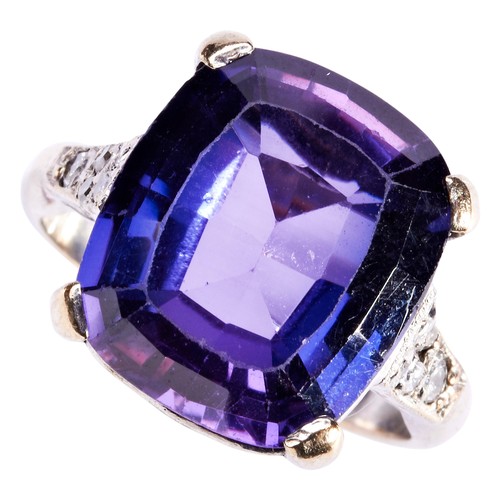 260 - A SYNTHETIC COLOUR CHANGE CORUNDUM AND DIAMOND RINGthe cushion-cut stone four claw set above pierced... 