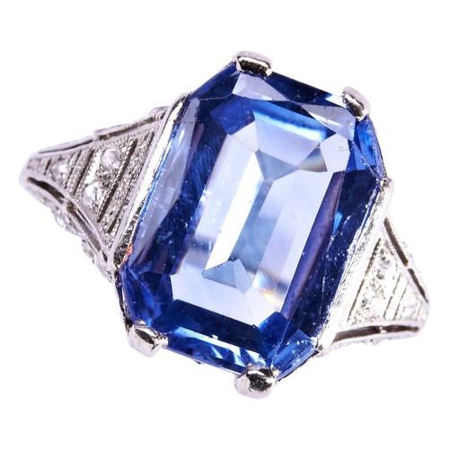 303 - A SAPPHIRE AND DIAMOND RING, CIRCA 1920the emerald-cut, cut cornered sapphire four claw, set above a... 