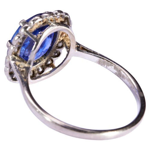 305 - A SAPPHIRE AND DIAMOND RING, CIRCA 1930the cushion cut sapphire six claw set within a border of eigh... 