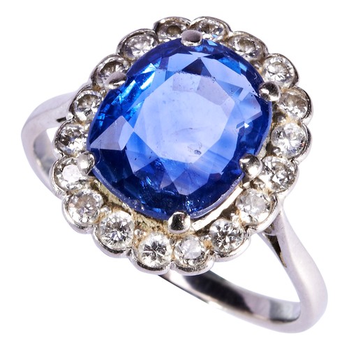 305 - A SAPPHIRE AND DIAMOND RING, CIRCA 1930the cushion cut sapphire six claw set within a border of eigh... 