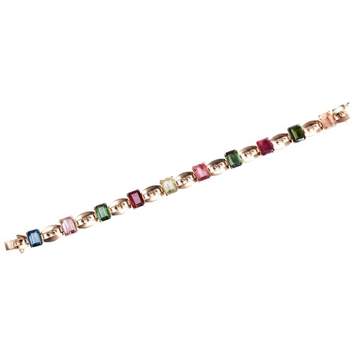 277 - A TOURMALINE AND GOLD BRACELET, CIRCA 1950the step-cut vari-coloured tourmalines all four claw set a... 