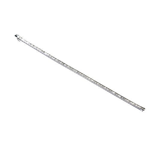 268 - A BAGUETTE CUT DIAMOND LINE BRACELETwith links of three baguette cut channel set diamonds. Tongue in... 