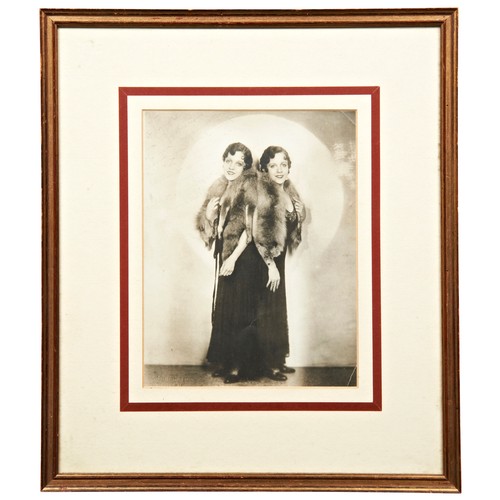 180 - DAISY & VIOLET HILTON, A SIGNED PHOTOGRAPH OF THE CONJOINED TWINS wearing fox stoles, the inscri... 