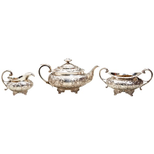 848 - A REGENCY SILVER TEA POT, SUGAR BOWL AND JUG, fluted baluster form with ornate floral repousse decor... 