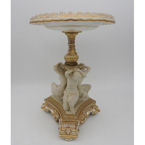 215 - A COPELAND PORCELAIN CENTREPIECE / COMPOTE, with a reticulated circular top supported by three kneel... 