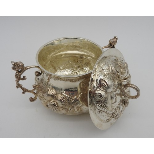 830 - A SILVER PORRINGER AND COVER, repousse decoration depicting a lion and unicorn amongst a profusion o... 