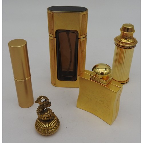 654 - A GROUP OF FIVE PERFUME BOTTLES, including two Cartier atomisers, a Hermes atomiser modelled as a hi... 