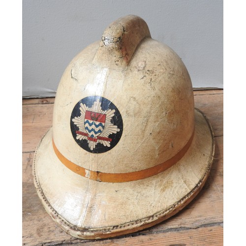 653 - A VINTAGE SHOP MANNEQUIN, CIRCA 1975, wearing a vintage fireman's helmet, fixed to a square metal ba... 