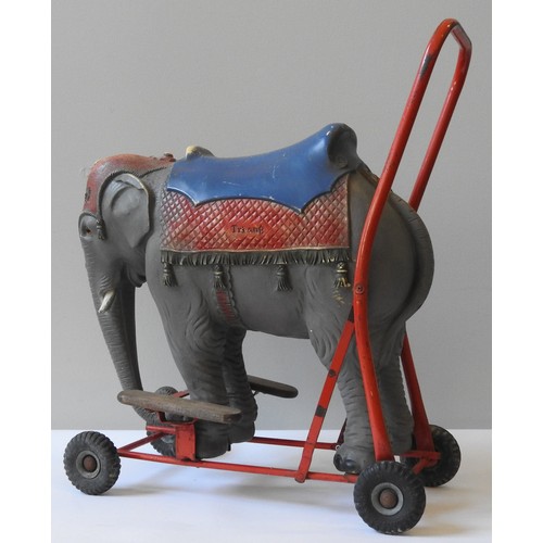 233 - A VINTAGE TRI-ANG RIDE ON PUSH ALONG ELEPHANT , CIRCA 1960, naturalistic  model mounted on a tubular... 