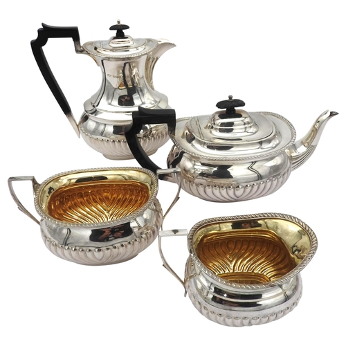 850 - A FOUR PIECE SILVER TEA SET, boat form with gadrooned decoration, marked Sheffield 1927. Approx 1790... 