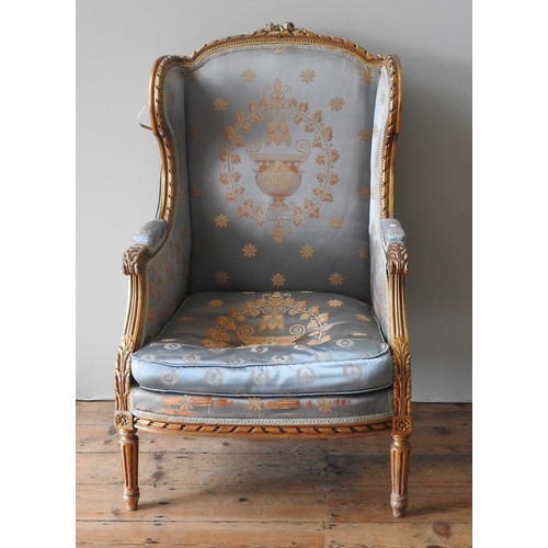 89 - A LOUIS XVI STYLE GILTWOOD WING BACK FAUTEUIL, 20TH CENTURY, high back frame with wing panel sides, ... 