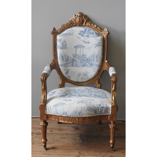 92 - A LOUIS XV STYLE GILTWOOD UPHOLSTERED FAUTEIUL, CIRCA 1900, foliate carved arch top rail with centra... 