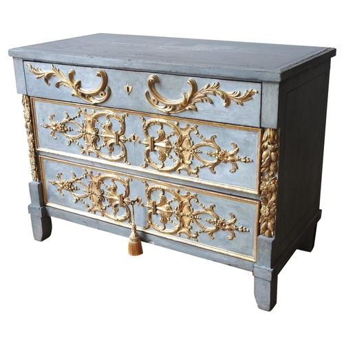 A CONTINENTAL PAINTED AND PARCEL GILT COMMODE, CIRCA 1800, rectangular top over three long drawers, flanked by ornate floral carved gilded uprights, the drawer fronts decorated with applied symmetrical scroll foliate gilt decoration, the whole painted in an attractive teal blue