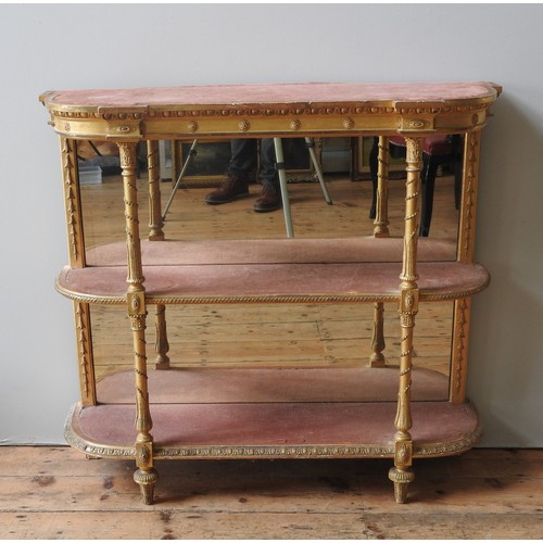 105 - A VICTORIAN GILTWOOD AND GESSO CREDENZA, 19TH CENTURY, bow front form, the three baize lined shelves... 