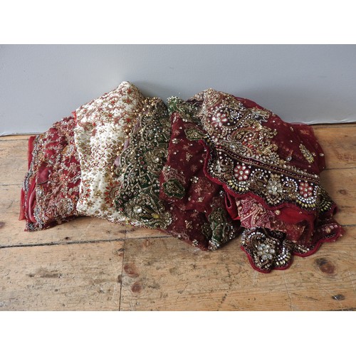 656 - A TRADITIONAL INDIAN BEADED, SEQUIN AND RHINESTONE ENCRUSTED WEDDING SKIRT and three similarly decor... 