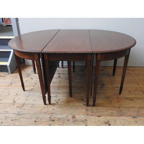 82 - A REGENCY MAHOGANY DINING ROOM TABLE WITH CENTRAL DROP FLAP SECTION AND TWO 'D' ENDS, THE WHOLE WITH... 